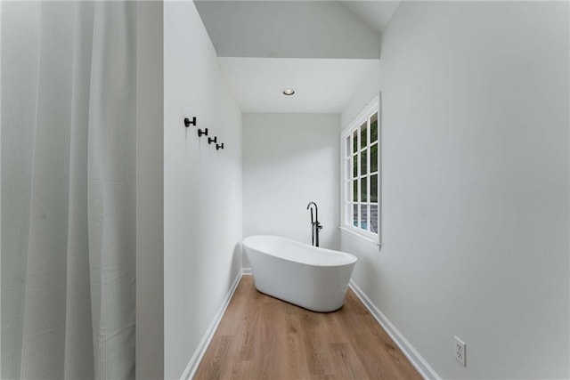 3285 Country Walk Dr, Powder Springs, GA 30127 - full bath featuring wood finished floors, baseboards, and a freestanding bath