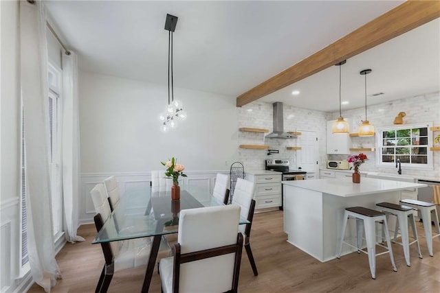 3285 Country Walk Dr, Powder Springs, GA 30127 - dining area featuring beamed ceiling, wood finished floors, a chandelier, wainscoting, and a decorative wall