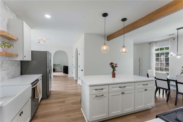 3285 Country Walk Dr, Powder Springs, GA 30127 - kitchen with open shelves, arched walkways, light countertops, hanging light fixtures, and beam ceiling