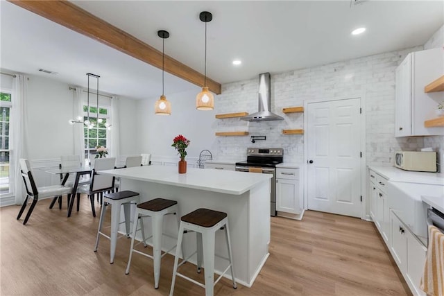 3285 Country Walk Dr, Powder Springs, GA 30127 - kitchen with open shelves, stainless steel range with electric cooktop, wall chimney range hood, white microwave, and tasteful backsplash