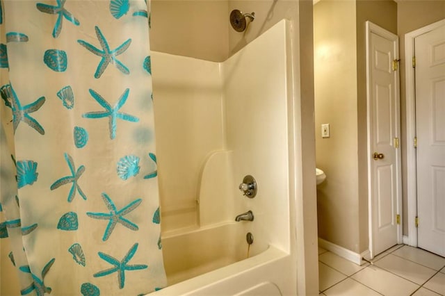 bathroom with tile patterned flooring, baseboards, and shower / bath combo with shower curtain