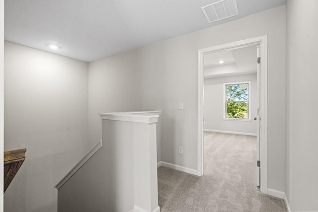 hall featuring light colored carpet