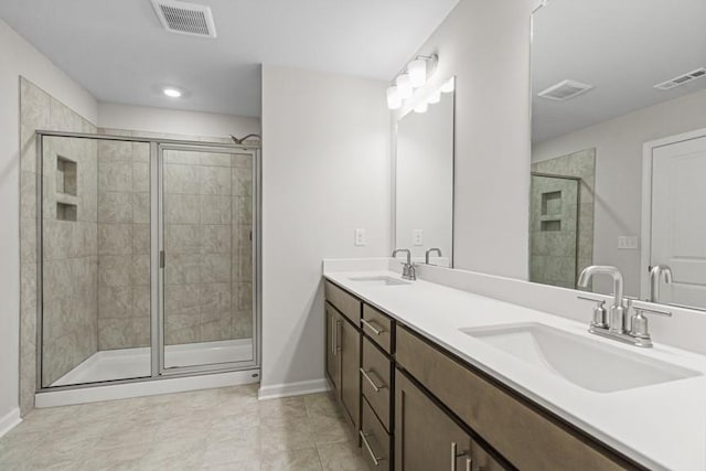 bathroom with vanity, tile patterned flooring, and a shower with door