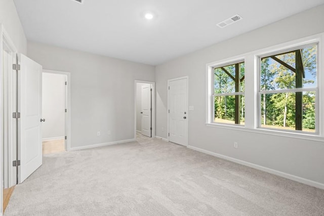 unfurnished bedroom with light colored carpet