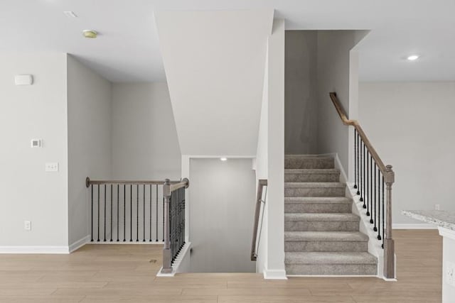 stairway featuring hardwood / wood-style floors