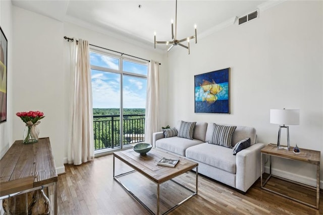 living room featuring hardwood / wood-style flooring and an inviting chandelier