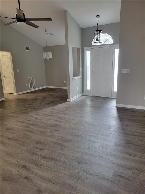 foyer entrance featuring dark wood-style floors, high vaulted ceiling, and visible vents