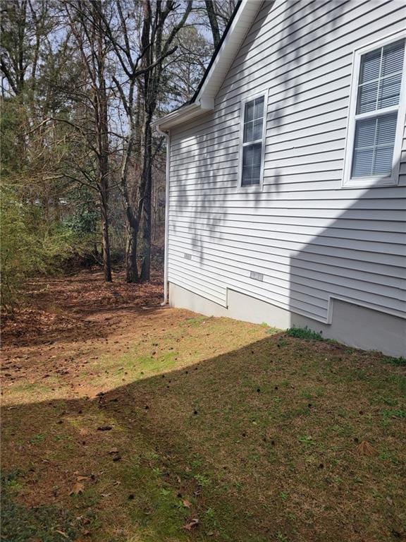 view of property exterior with a yard