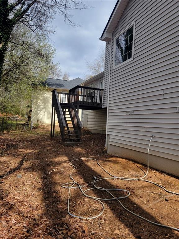 view of yard with stairway and a wooden deck