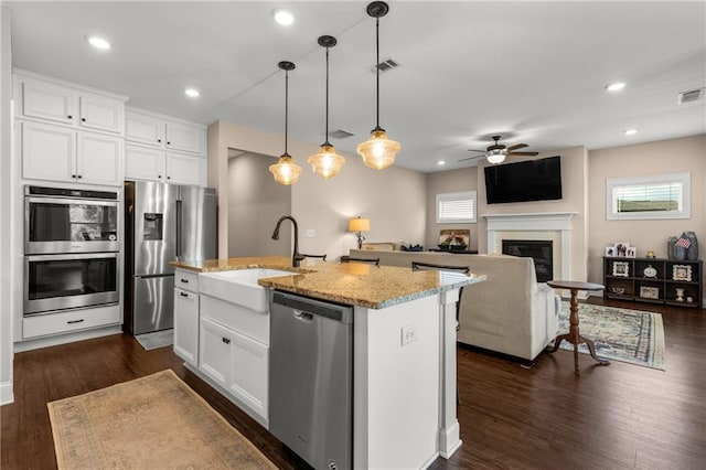 508 Windy Ridge Ct, Canton, GA 30114 - kitchen with appliances with stainless steel finishes, ceiling fan, light stone countertops, a kitchen island with sink, and white cabinets