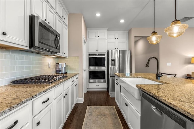 508 Windy Ridge Ct, Canton, GA 30114 - kitchen with stainless steel appliances, dark wood-style flooring, white cabinetry, light stone counters, and recessed lighting