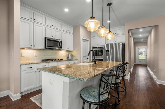 508 Windy Ridge Ct, Canton, GA 30114 - kitchen with stainless steel appliances, dark wood-style floors, white cabinetry, and recessed lighting