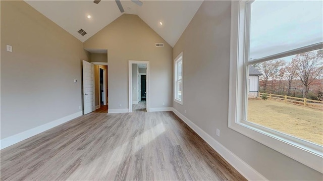 unfurnished bedroom with ceiling fan, high vaulted ceiling, and light hardwood / wood-style floors