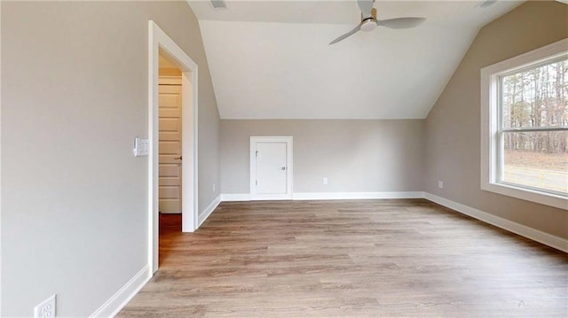 additional living space featuring vaulted ceiling, ceiling fan, and light hardwood / wood-style flooring