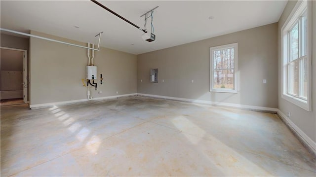 garage featuring water heater, a garage door opener, and electric panel