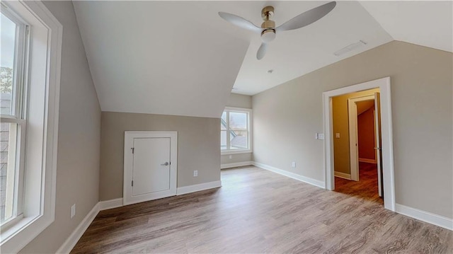 additional living space with vaulted ceiling, ceiling fan, and light wood-type flooring