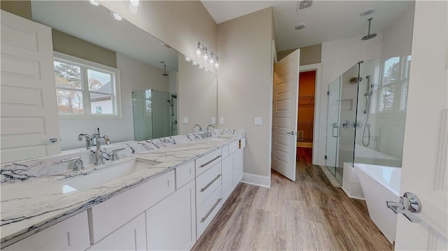 bathroom featuring vanity, hardwood / wood-style floors, and shower with separate bathtub