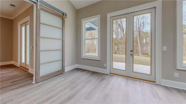 doorway to outside featuring french doors, crown molding, and light hardwood / wood-style flooring