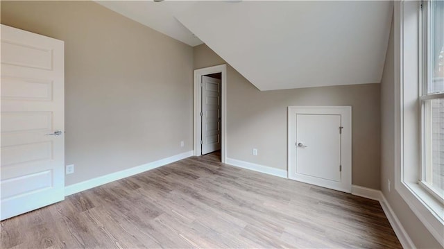 bonus room featuring light hardwood / wood-style floors and lofted ceiling