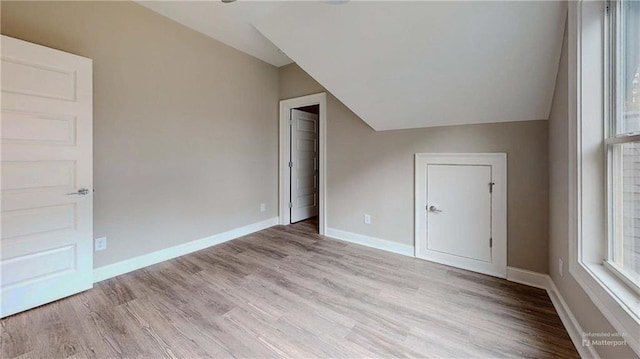 interior space featuring lofted ceiling and light wood-type flooring