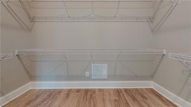 spacious closet featuring hardwood / wood-style flooring