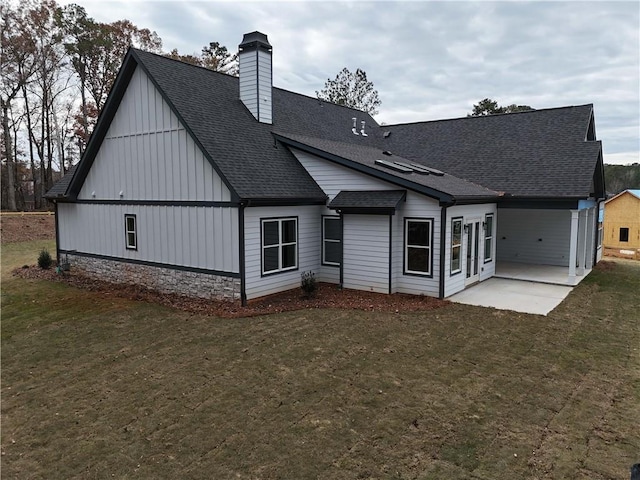 rear view of property featuring a yard and a patio