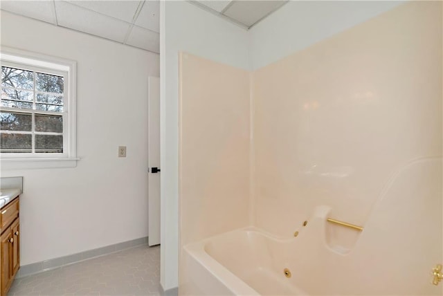 bathroom with tile patterned flooring, vanity, and a paneled ceiling