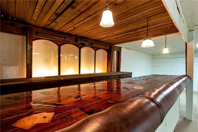 interior space featuring wood ceiling and carpet flooring