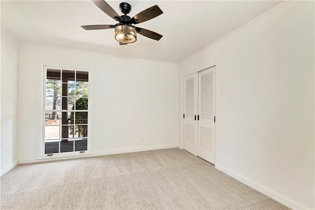 unfurnished bedroom with light carpet, ornamental molding, a closet, and ceiling fan