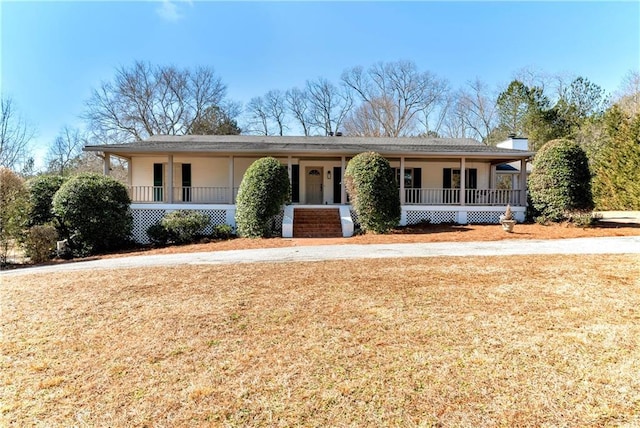 view of front of home featuring covered porch and a front yard