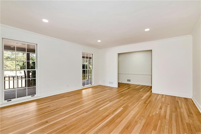 unfurnished room with crown molding and light wood-type flooring