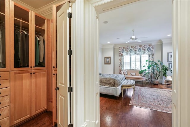 corridor featuring dark hardwood / wood-style floors and crown molding