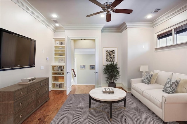 living room with ceiling fan, wood-type flooring, and ornamental molding