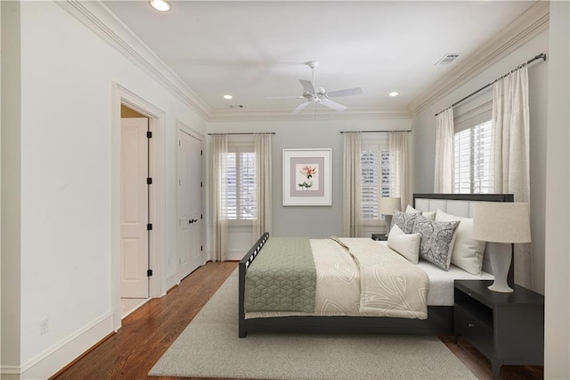 bedroom featuring ceiling fan, dark hardwood / wood-style flooring, and ornamental molding