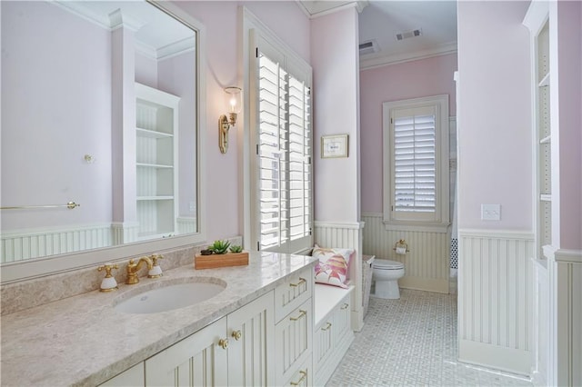 bathroom featuring tile patterned flooring, vanity, toilet, and ornamental molding