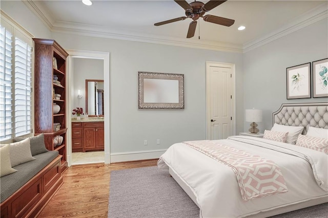 bedroom with ceiling fan, light wood-type flooring, ornamental molding, and connected bathroom