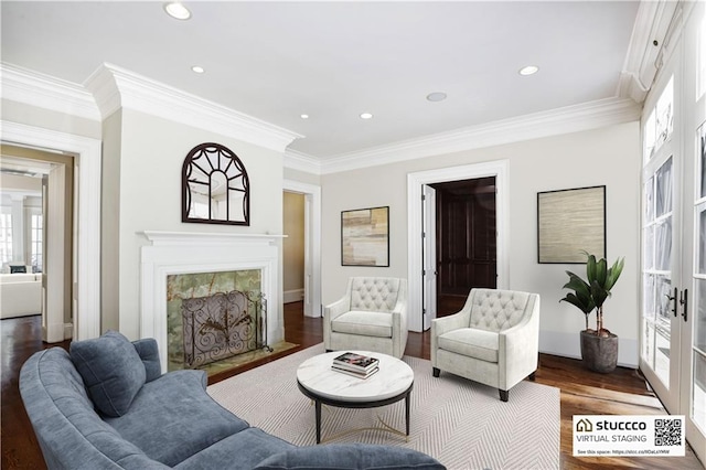 living room featuring dark hardwood / wood-style flooring, crown molding, a high end fireplace, and french doors