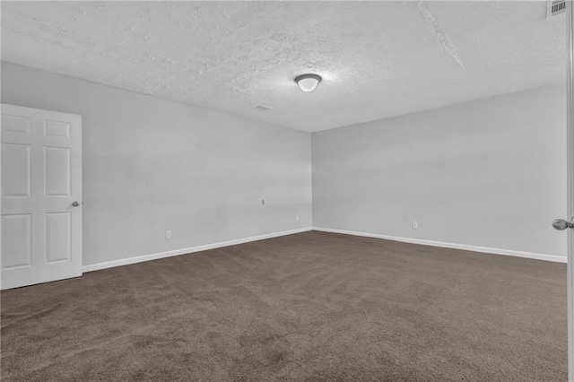 2044 Teal Cv, Lithonia, GA 30058 - spare room with baseboards, a textured ceiling, visible vents, and dark carpet