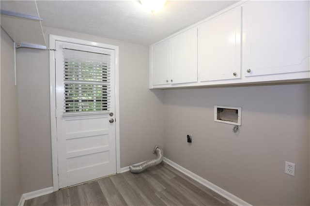 laundry room featuring cabinets, wood-type flooring, hookup for a washing machine, and electric dryer hookup