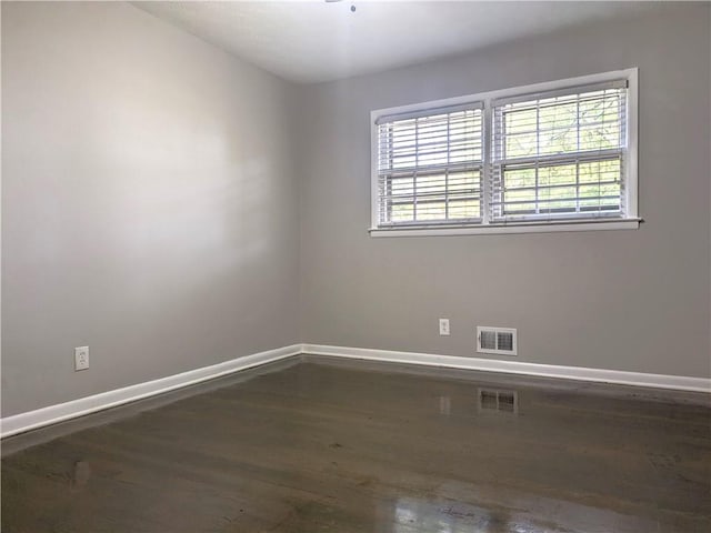 spare room featuring dark hardwood / wood-style floors