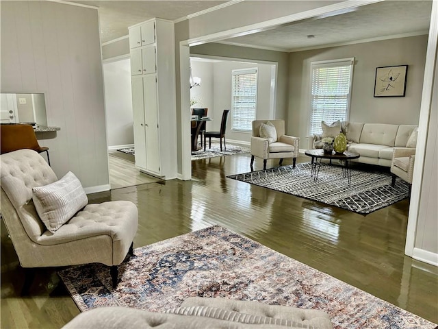 living room featuring light hardwood / wood-style flooring, wood walls, and crown molding