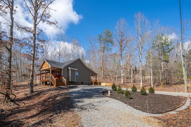 view of home's exterior with covered porch and driveway