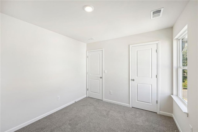 unfurnished bedroom with light colored carpet