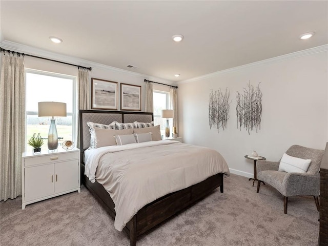 bedroom with ornamental molding and light colored carpet