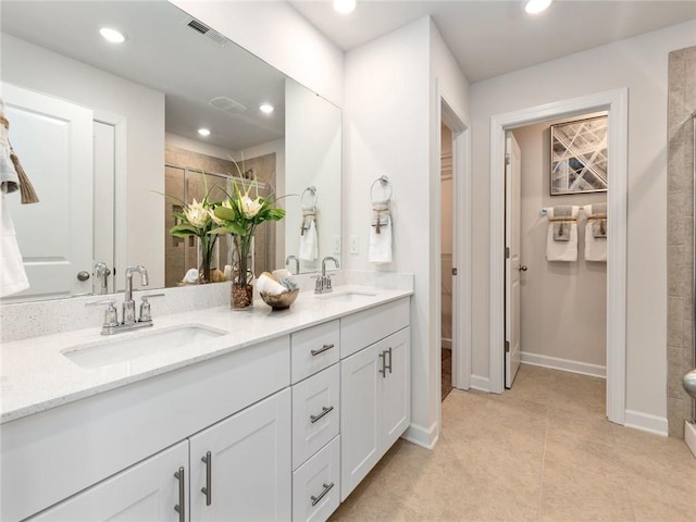 bathroom with vanity, tile patterned floors, and tiled shower