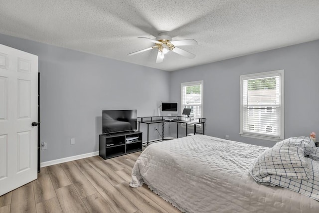3910 Meeting St, Duluth, GA 30096 - bedroom with wood finished floors, a textured ceiling, baseboards, and ceiling fan