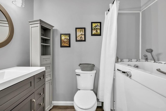 3910 Meeting St, Duluth, GA 30096 - full bath featuring toilet, vanity, wood finished floors, and a bathtub