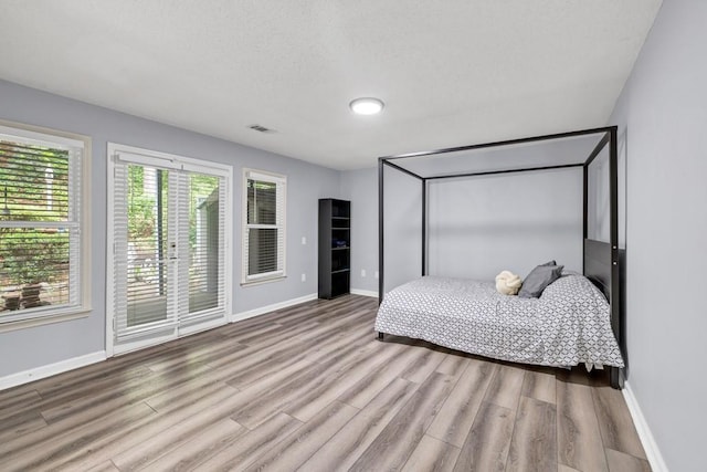 3910 Meeting St, Duluth, GA 30096 - bedroom with baseboards, wood finished floors, and a textured ceiling