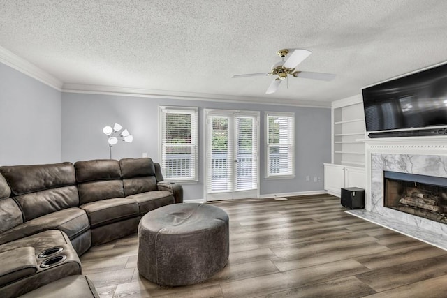 3910 Meeting St, Duluth, GA 30096 - living area featuring ornamental molding, a textured ceiling, wood finished floors, a ceiling fan, and a premium fireplace