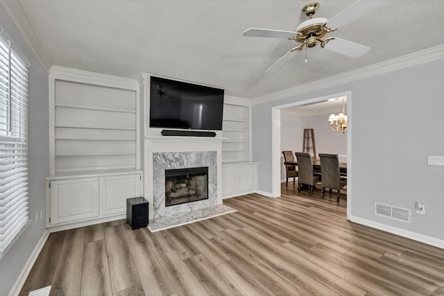 3910 Meeting St, Duluth, GA 30096 - living room featuring baseboards, crown molding, wood finished floors, a high end fireplace, and built in shelves